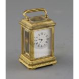 A late 19th century French miniature ormolu carriage timepiece, with engraved case and enamelled