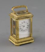 A late 19th century French miniature ormolu carriage timepiece, with engraved case and enamelled