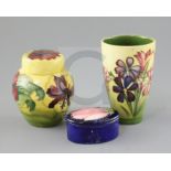 A Moorcroft 'spring flowers' vase, a 'hibiscus' jar and cover and a 'magnolia' trinket box and