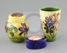 A Moorcroft 'spring flowers' vase, a 'hibiscus' jar and cover and a 'magnolia' trinket box and