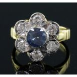 A modern 18ct gold, sapphire and diamond seven stone flowerhead cluster ring, size J/K.