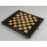 An early 19th century ebony and boxwood travelling games box, with external chess board and internal
