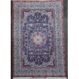 A fine Tabriz blue ground rug, with farsi inscription and central medallion in a field of