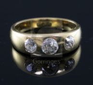 An 18ct gold and gypsy set three stone diamond ring, size N.