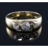 An 18ct gold and gypsy set three stone diamond ring, size N.