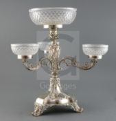 A late Victorian Walker & Hall silver plated centrepiece, the central cut glass bowl raised on a