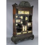 A Japanese Meiji period carved wood and shibayama cabinet, blind fret carved throughout and