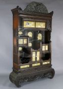 A Japanese Meiji period carved wood and shibayama cabinet, blind fret carved throughout and