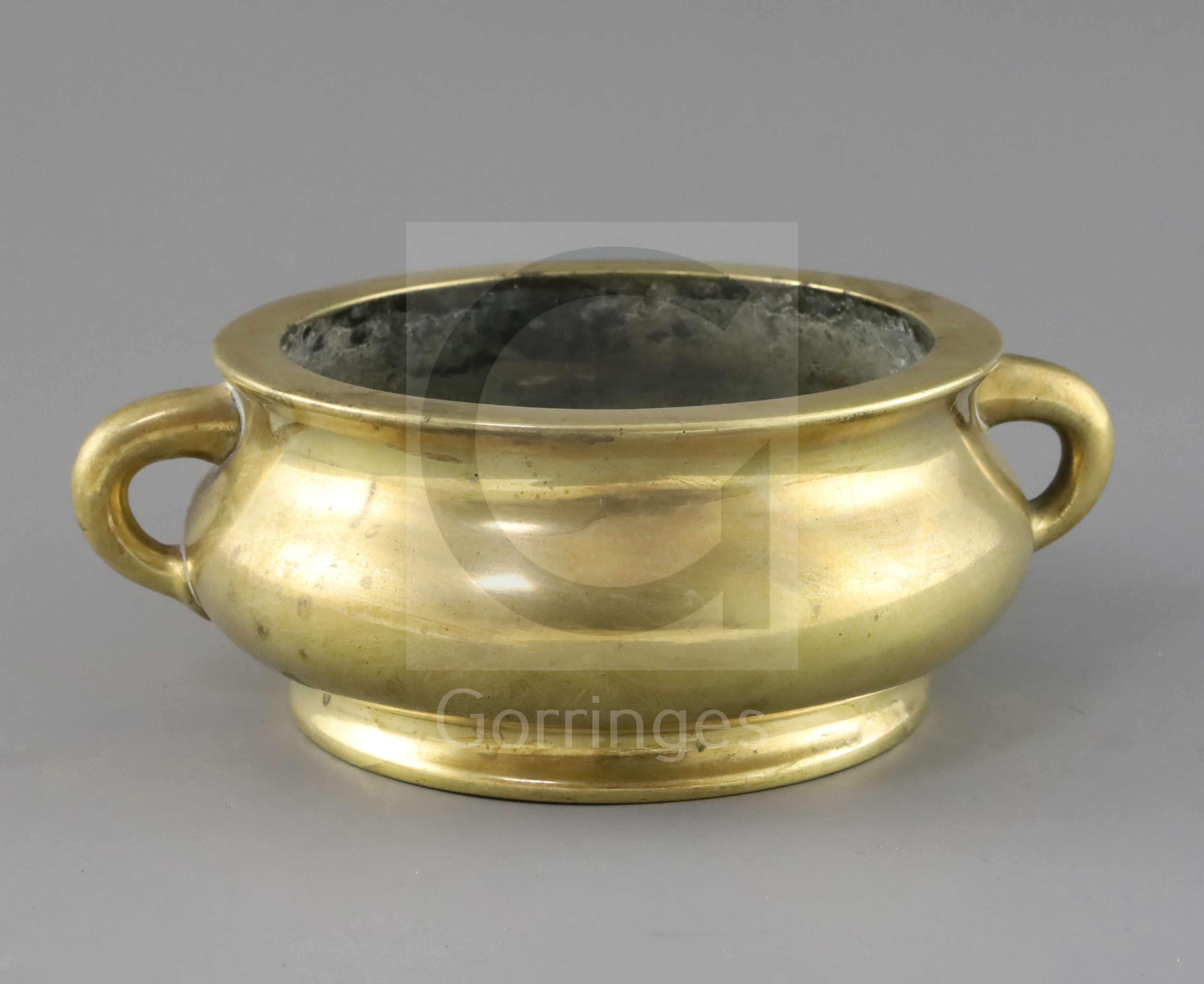 A good Chinese polished bronze censer, gui, 17th/18th century, applied with a pair of lug handles,