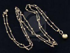 An Edwardian 15ct gold guard chain, with sphere and elongated links and ball charm, approximately