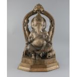 A late 19th century Indian rosewood figure of Ganesh, with ivory tusks, four arms holding various