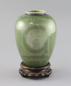 A Chinese green Jun-type vase, 19th century, with a fine crackle to the glaze, H. 17cm, wood stand