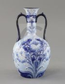 A Moorcroft Florian ware two handled vase, c.1900, decorated with blue and white flowers, brown