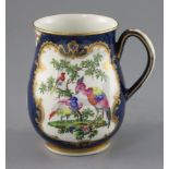 A good Worcester scale blue mug, c.1768-70, of bell shape, painted with exotic birds and butterflies