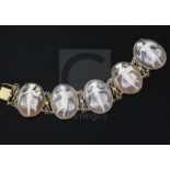 A 14ct gold and oval cameo bracelet, set with five cameos carved with muses, 18cm.