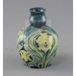 A Moorcroft Florian ware small vase, c.1902-5, decorated predominantly in green, blue and yellow