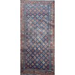 An antique Bidjar carpet, with field of foliate motifs, on a blue ground, 11ft 4in by 5ft 4in