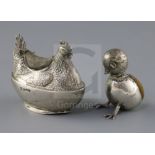An Edwardian novelty silver pin cushion, modelled as a hatching chick with protruding head and feet,