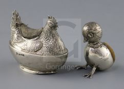 An Edwardian novelty silver pin cushion, modelled as a hatching chick with protruding head and feet,