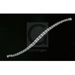 A 20th century 14ct white gold, graduated sapphire and diamond twin line bracelet, set with one