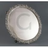 An early George III silver circular salver, by Richard Rugg I, with cast pierced trellis border