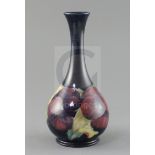 A Moorcroft 'pansy' bottle vase, c.1917, impressed marks Moorcroft Burslem England 50, inscribed