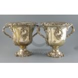 An ornate pair of 19th century Old Sheffield plate two handled pedestal wine coolers, with removable