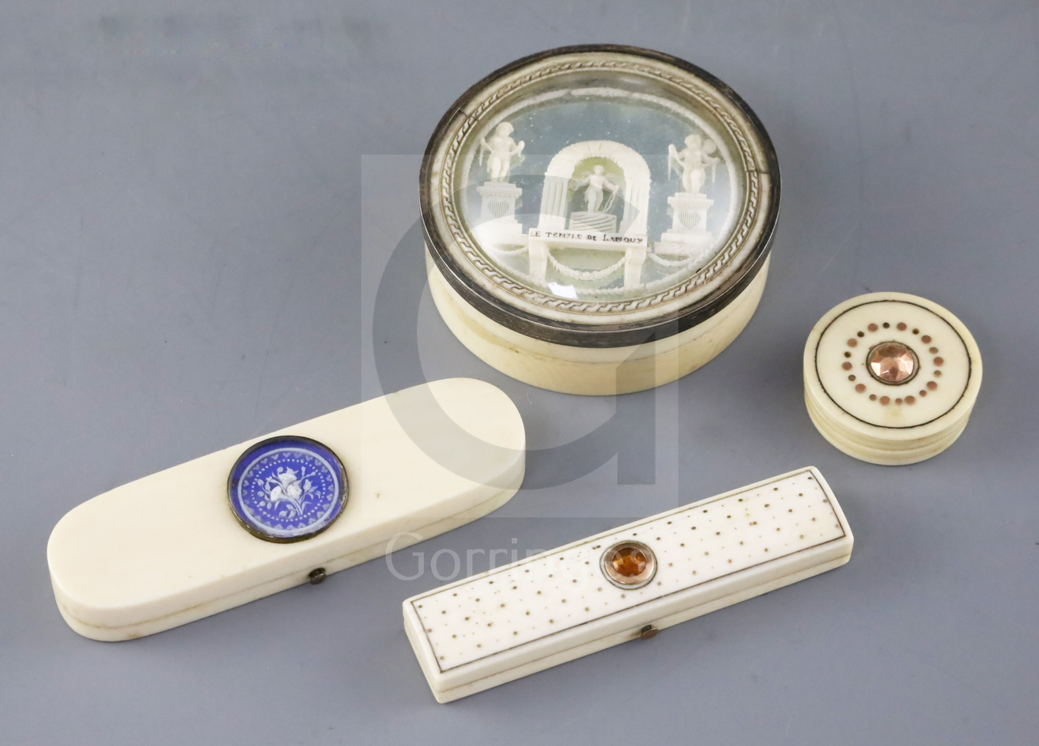 An early 19th century French ivory circular box, two late Georgian ivory toothpick cases and an