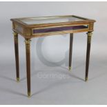 An early 20th century French ormolu mounted mahogany display table, with rising top and foliate