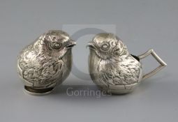 An Edwardian novelty silver cream jug and sugar sifter, each modelled as a hatching chick, by
