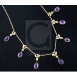 An Edwardian 15ct gold, amethyst, peridot and seed pearl set drop necklace, 40cm.