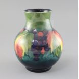 A Moorcroft 'leaf and berry' baluster vase, 1950's, impressed marks Moorcroft Made in England,