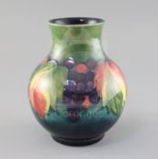 A Moorcroft 'leaf and berry' baluster vase, 1950's, impressed marks Moorcroft Made in England,