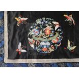 A Chinese embroidered black satin table frontal, late Qing dynasty, decorated with floral