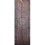 An antique Karabagh runner, with rows of geometric motifs on a green ground, 17ft 2in by 6ft 10in.