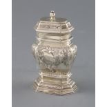 A late George I silver narrow bombe shaped tea caddy, with later embossed foliate decoration and