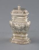 A late George I silver narrow bombe shaped tea caddy, with later embossed foliate decoration and
