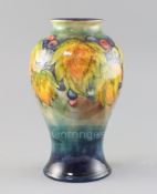 A Moorcroft 'leaf and berry' flambe baluster vase, 1930's, impressed marks W.Moorcroft Potter to