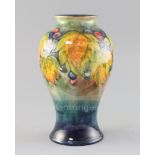 A Moorcroft 'leaf and berry' flambe baluster vase, 1930's, impressed marks W.Moorcroft Potter to
