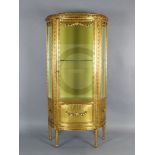 A Louis XVI style carved giltwood vitrine, with bevelled glazing and single door, on toupie feet,