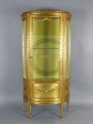A Louis XVI style carved giltwood vitrine, with bevelled glazing and single door, on toupie feet,