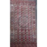 An antique Tekke Bokhara carpet, with field of polygons, on a red ground, with multi row border,