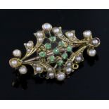 An Edwardian gold, split pearl and demantoid garnet set brooch, the back with engraved