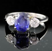 An 18ct white gold, sapphire and diamond three-stone ring, size N.