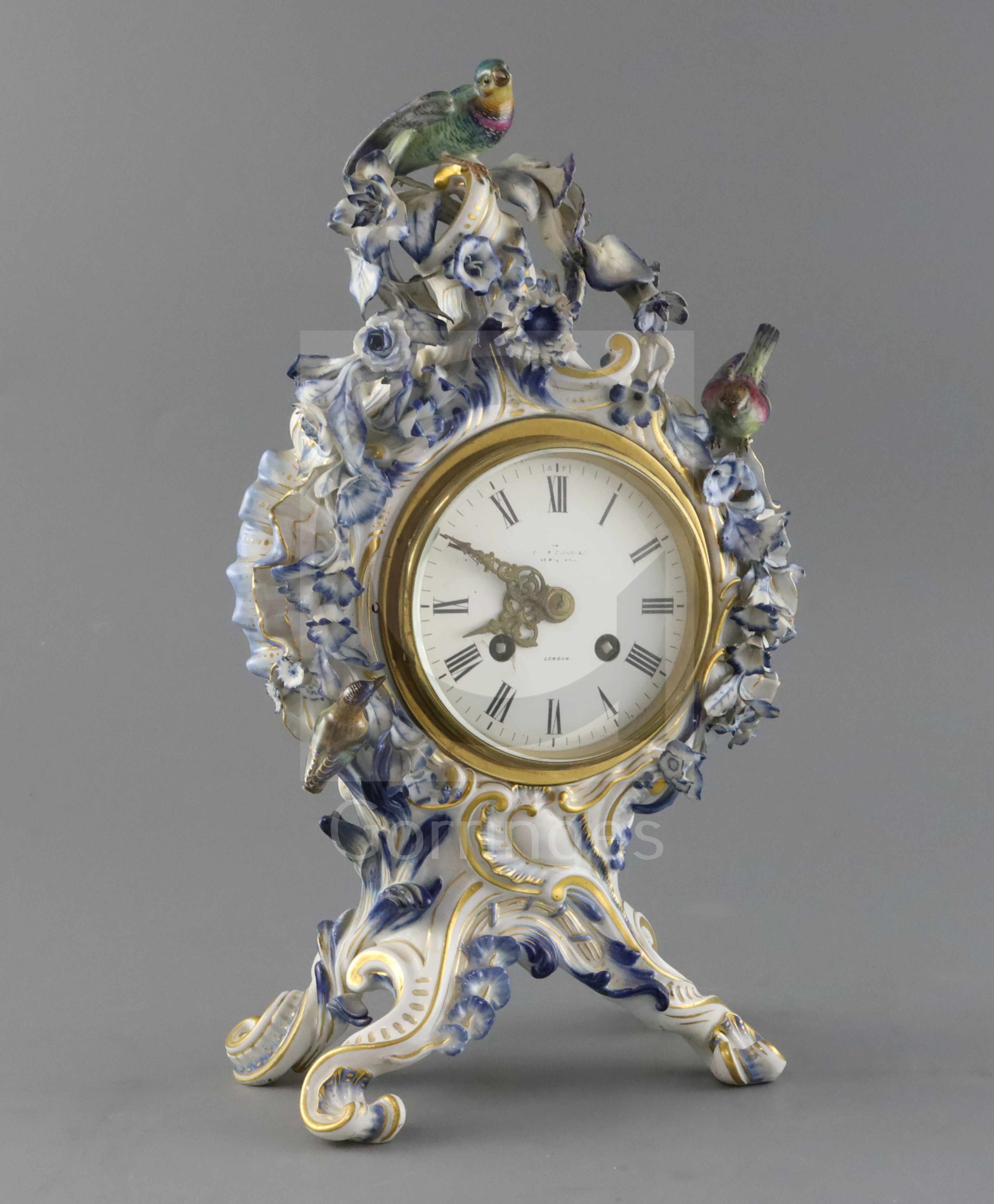 A Meissen flower encrusted mantel clock, late 19th century, of cartouche shape, surmounted by two