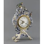 A Meissen flower encrusted mantel clock, late 19th century, of cartouche shape, surmounted by two