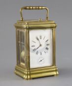 An early 20th century French hour repeating carriage alarum clock, with enamelled Roman dial,