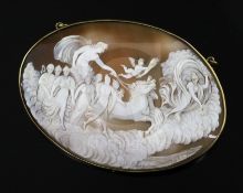 A large late Victorian gilt metal mounted oval cameo pendant brooch, carved with chariot, muses and