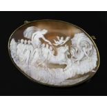 A large late Victorian gilt metal mounted oval cameo pendant brooch, carved with chariot, muses and