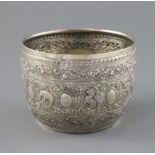 An early 20th century Burmese silver small bowl, decorated with panels of various animals amongst